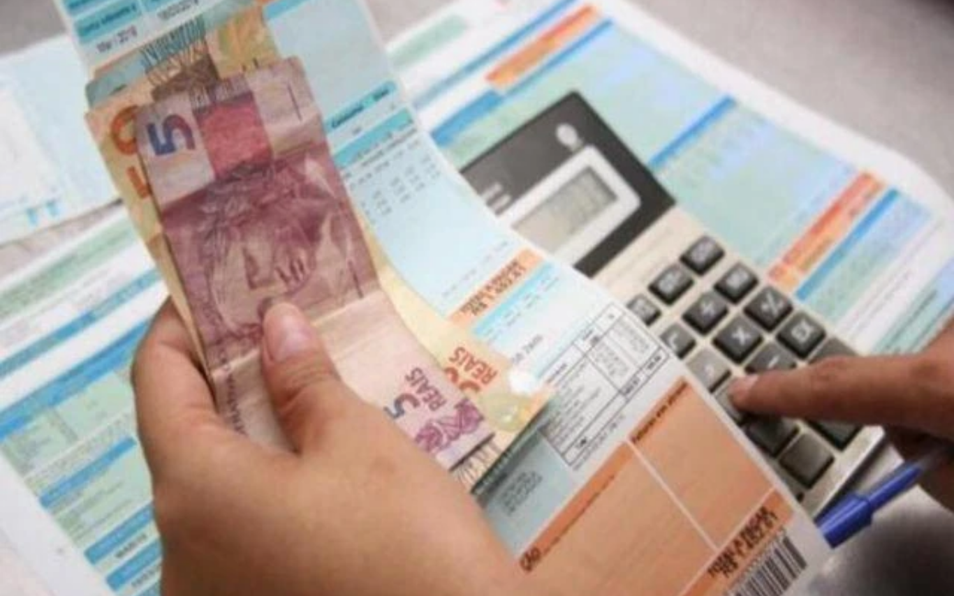 Pessoa faz contas com dinheiro na mão